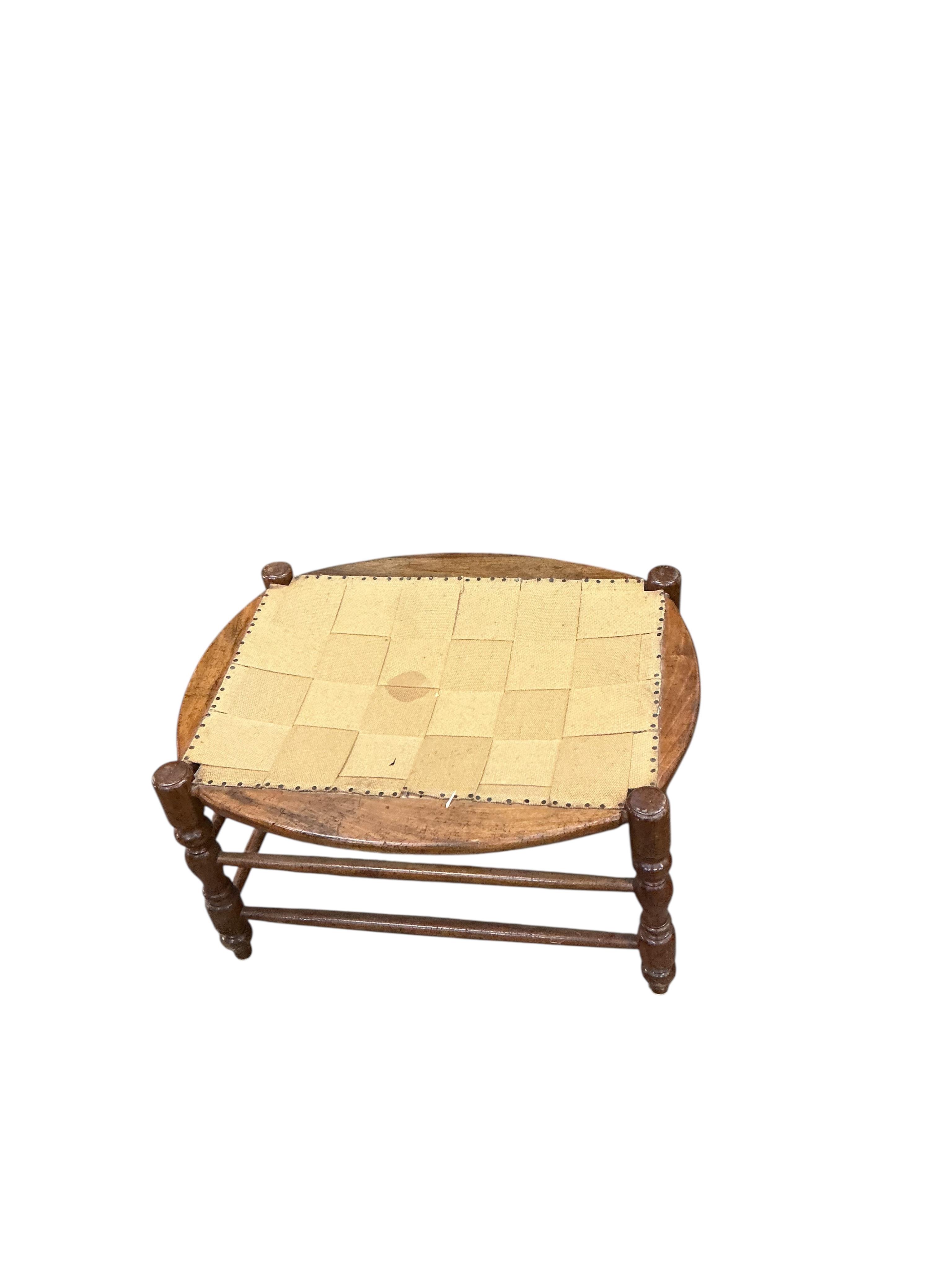 A 19th century French fruitwood armchair, width 70cm, depth 64cm, height 112cm and foot stool